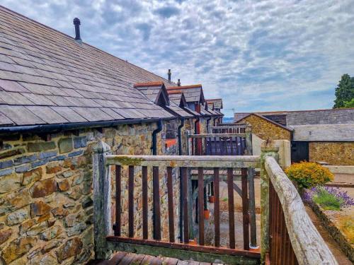a wooden fence in front of a stone building at Clyne Farm Centre in The Mumbles