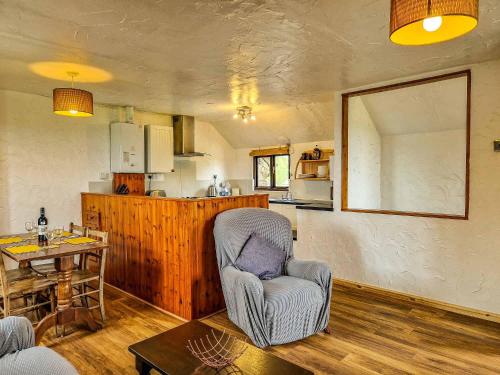 a living room with a chair and a table at Clyne Farm Centre in The Mumbles