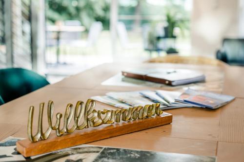 a wooden table with a bunch of gold utensils on it at Villa Lieboch in Lieboch