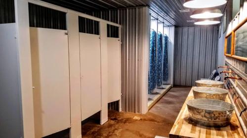 a locker room with a row of buckets on a table at Letchworth Valley Campground Cabins in Bliss