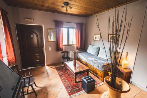 a living room with a couch and a table at Georgio's V Chalet Kalavrita in Kalavrita