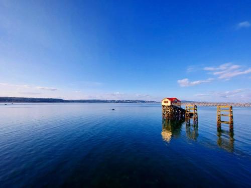 a dock in the middle of a large body of water at Clyne Farm Centre in The Mumbles