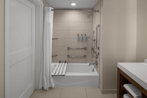 a white bathroom with a tub and a shower at Residence Inn by Marriott Durham Duke University Medical Center Area in Durham