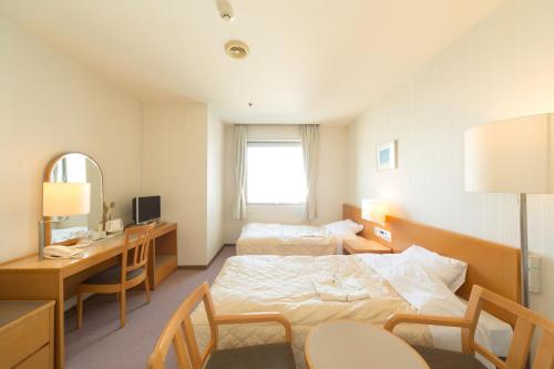 Postel nebo postele na pokoji v ubytování Hiroshima International Youth House JMS Aster Plaza