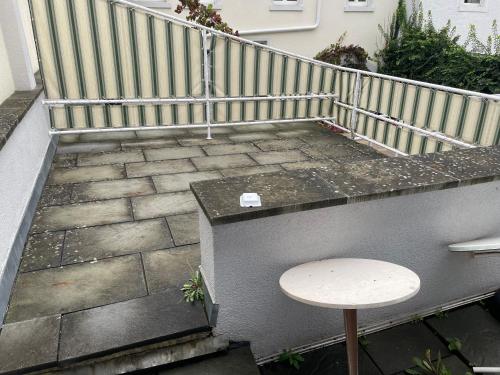 a small table on a balcony with a railing at Monteurwohnung Holländer in Bruchsal