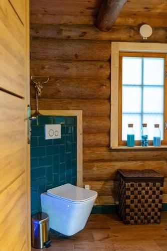 a bathroom with a toilet in a wooden house at Mysig timmerhus i skogen med privat bastu nära sjön in Orkelljunga