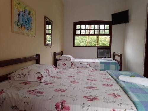 Ein Bett oder Betten in einem Zimmer der Unterkunft Pousada Astro Rei Paraty