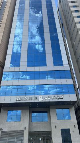 a reflection of the sky in the windows of a building at el maqam el zahbe in Al Khansāk