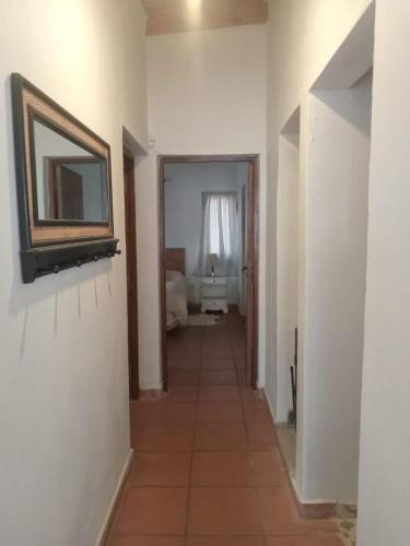 a hallway of a room with a mirror and a bathroom at Las Piedras in Tafí del Valle
