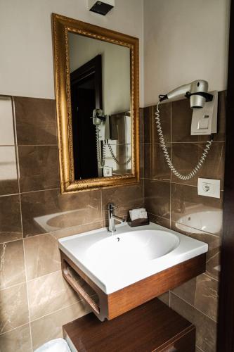 a bathroom with a sink and a mirror at Rouge Hotel International in Milano Marittima