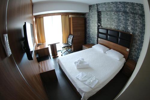 a bedroom with a bed with two towels on it at Bayraktar Hotel in Akcakoca