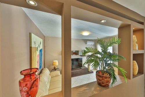 a living room with a large vase and a plant at Villa Antonija in Ražanj