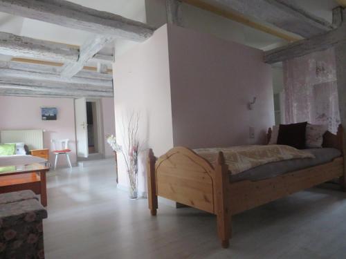 a bedroom with a wooden bed in a room at Gutshaus Darsikow in Darsikow