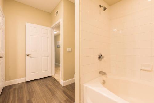 a bathroom with a white tub and a shower at Spacious Apt with Private Balcony in Waltham