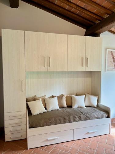 a bed in a room with white cabinets at My Tuscany Relais in Altopascio