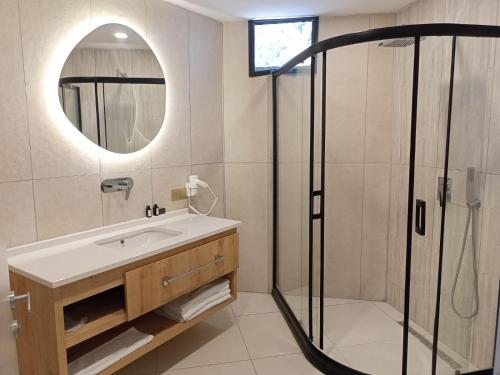 a bathroom with a sink and a shower at Casalita Hotel in Kizkalesi