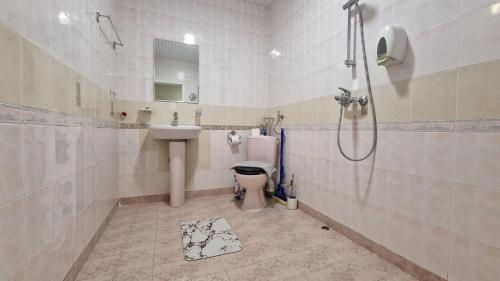a bathroom with a sink and a toilet and a shower at Морски Рай in Varna City