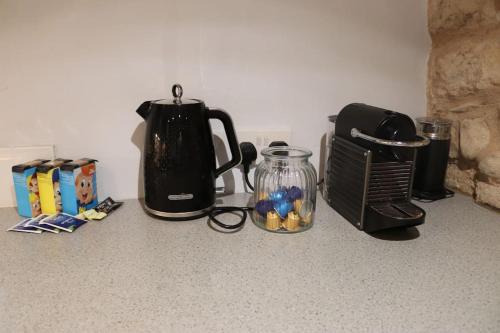 a kitchen counter with a coffee maker and a blender at Historic 3 double bed whole house by castle in Lancaster
