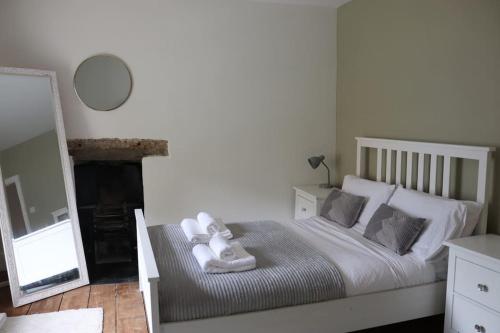 a bedroom with a bed with towels on it at Historic 3 double bed whole house by castle in Lancaster