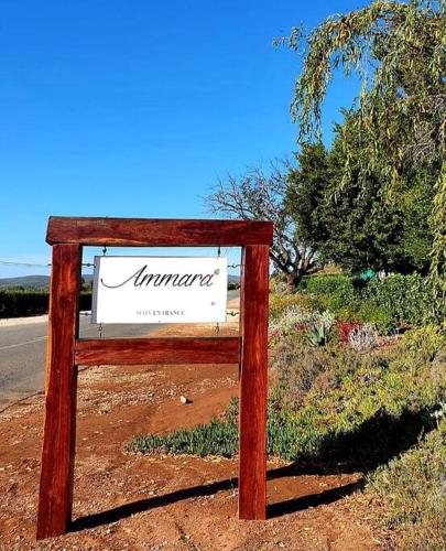 a sign sitting on the side of a road at Ammara Farmstay in Bonnievale