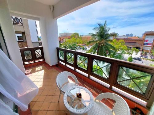a balcony with two chairs and a table with a view at Good2Stay Apartment 6-8pax l 3R2B l 2 Parking l Coway Water l Unifi I Swimming Pool in Melaka