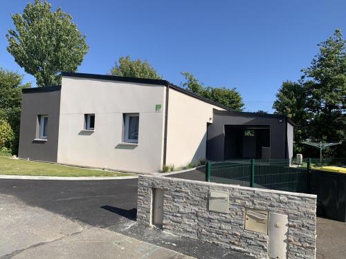 a white house with a black roof at Ker sandra in Saint-Germain-en-Coglès