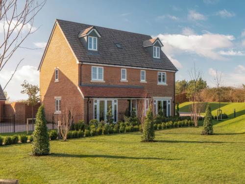a large brick house with a yard at Goodwood Retreat in Chichester