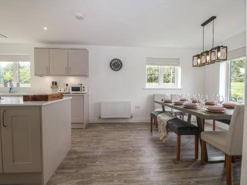 a kitchen and dining room with a table and chairs at Goodwood Retreat in Chichester