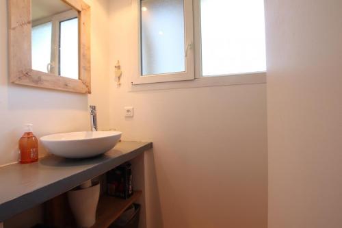 a bathroom with a sink and a window at Chez fontaine in Lahonce
