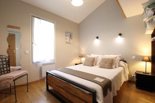 a bedroom with a large bed and a window at Chez fontaine in Lahonce