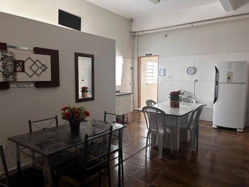 a kitchen and dining room with a table and a refrigerator at Hospedagem Recanto Miriam -Salto in Salto