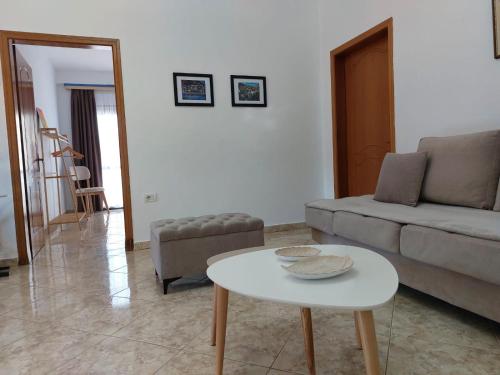 a living room with a couch and a table at Wendy's Apartment in Berat