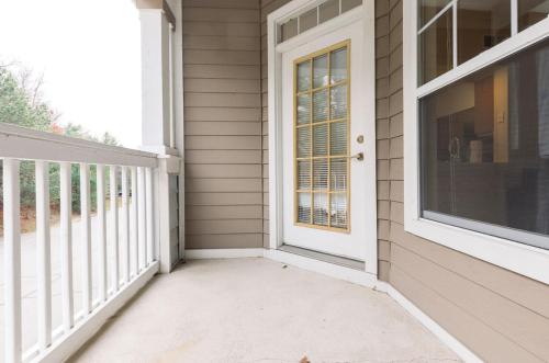 a porch with a white door and a window at Spacious Apt with Private Balcony in Waltham