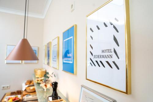 a row of framed pictures hanging on a wall at Das Jedermann Boutiquehotel mit Stadtgarten in Salzburg