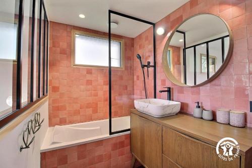 a bathroom with a sink and a mirror at Villa Namasté SPA Hammam port & Mer in La Trinité-sur-Mer
