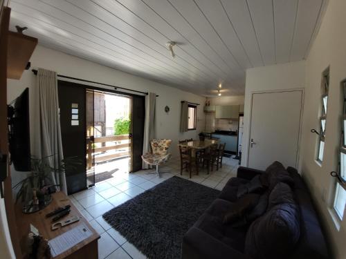 a living room with a couch and a table at Pousada Recanto do Aconchego in Florianópolis