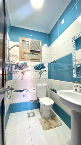 a bathroom with a toilet and a sink at aswan view 3 bedrooms in Aswan