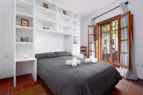 a bedroom with a bed with two stuffed animals on it at Casa Lucero Ronda in Ronda