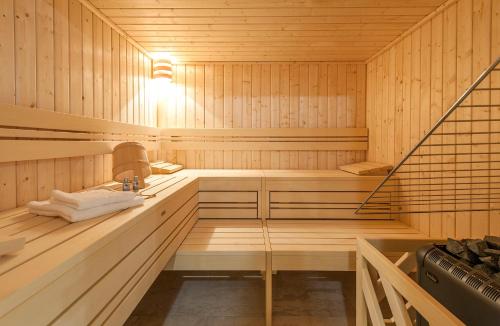 a sauna with wooden walls and a staircase in it at Alpin Chalet Schröcken in Schröcken