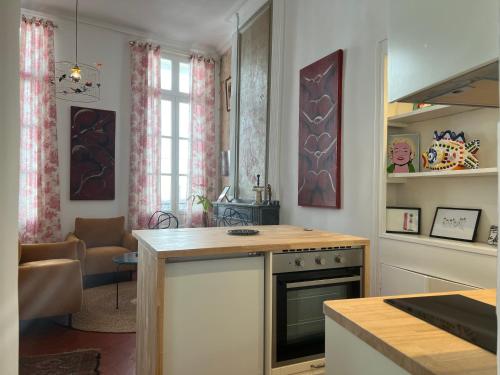 une cuisine avec une cuisinière et un comptoir dans l'établissement LA SUITE - Appartement Centre Historique, à Montpellier