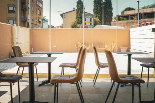 a row of tables and chairs on a patio at B&B Piccola Stella in Pisa