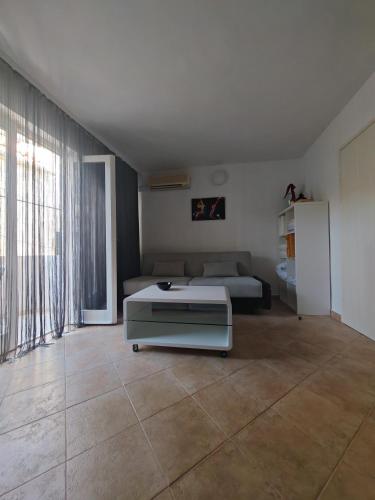 a living room with a bed and a couch at Apartments Marin in Tisno