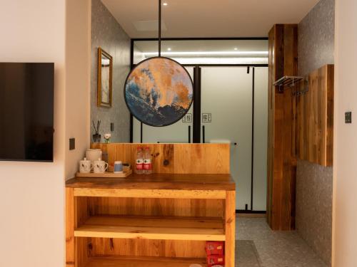 a room with a desk and a globe on the wall at Patio Spring Holiday Inn -- Free round trip pick-up service --Panoramic view of Tianmen Mount in Zhangjiajie