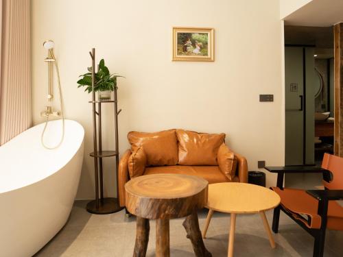 a living room with a couch and a table at Patio Spring Holiday Inn -- Free round trip pick-up service --Panoramic view of Tianmen Mount in Zhangjiajie
