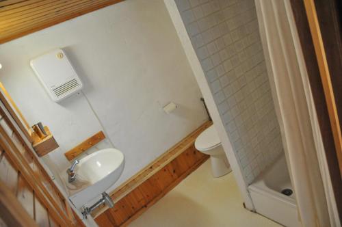 a small bathroom with a toilet and a sink at Oneux in Oneux
