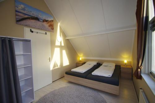 a small room with a bed and a closet at Kustverhuur, Breskens Zwin 051 in Breskens