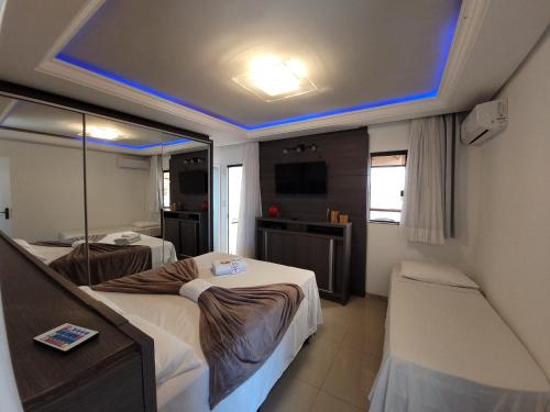 a room with two beds and a blue ceiling at Pousada Recanto do Aconchego in Florianópolis