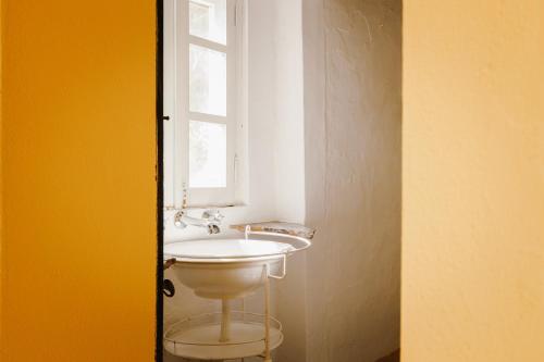 a bathroom with a sink and a window at Monte do Ramalho in Avis