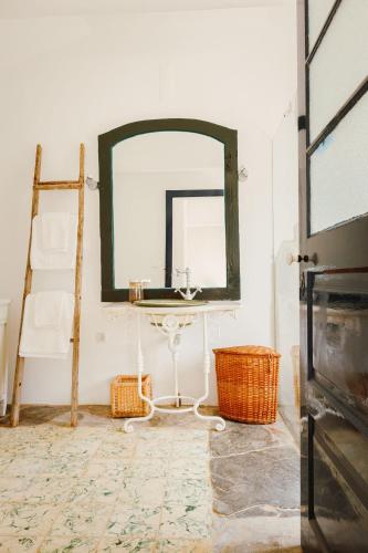 a bathroom with a mirror and a table and a ladder at Monte do Ramalho in Avis
