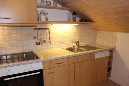 a kitchen with a sink and a stove at Ferienhof Bernegglehen in Berchtesgaden